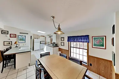 a kitchen and dining room with a wooden table at Put-in-Bay Island Club #61 in Put-in-Bay