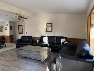 a living room with black leather couches and a coffee table at Put-in-Bay Island Club #61 in Put-in-Bay
