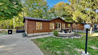 a small cabin with a picnic table in a park at Put-in-Bay Island Club #105 in Put-in-Bay