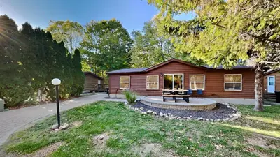 a log cabin with a bench in front of it at Put-in-Bay Island Club #105 in Put-in-Bay