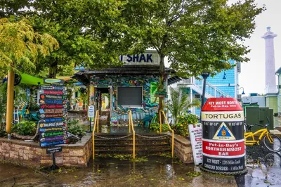 a small store with a sign in front of it at Put-in-Bay Island Club #105 in Put-in-Bay