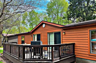 a house with a large deck with a porch at Put-in-Bay Island Club #98 in Put-in-Bay