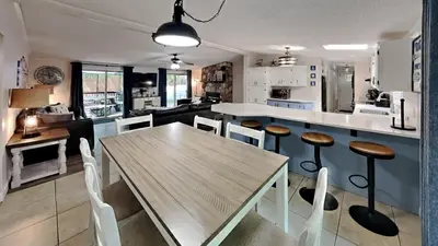 a kitchen and dining room with a wooden table and chairs at Put-in-Bay Island Club #95 in Put-in-Bay