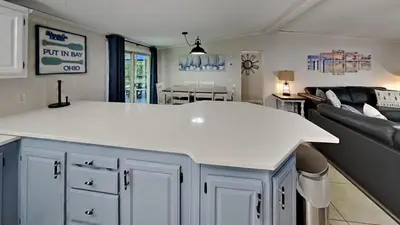 a kitchen with a white counter and a living room at Put-in-Bay Island Club #95 in Put-in-Bay