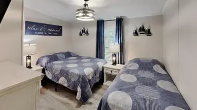 a bedroom with two beds and a mirror at Put-in-Bay Island Club #95 in Put-in-Bay