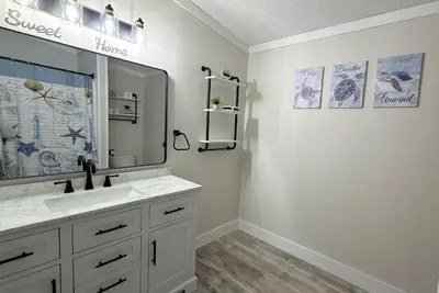 a bathroom with a sink and a mirror at Put-in-Bay Island Club #106 in Put-in-Bay