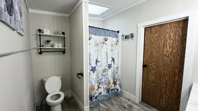 a bathroom with a toilet and a shower curtain at Put-in-Bay Island Club #106 in Put-in-Bay