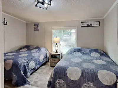 a bedroom with two beds and a window at Put-in-Bay Island Club #106 in Put-in-Bay