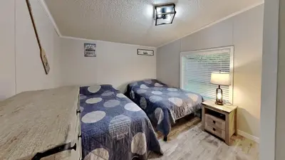 a bedroom with two beds and a window at Put-in-Bay Island Club #106 in Put-in-Bay