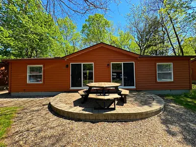 a house with a picnic table in front of it at Put-in-Bay Island Club #106 in Put-in-Bay