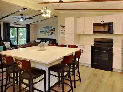 a kitchen and living room with a table and chairs at Put-in-Bay Island Club #68 in Put-in-Bay