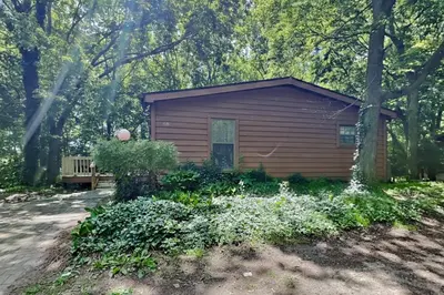 a small building with a bench in front of it at Put-in-Bay Island Club #68 in Put-in-Bay