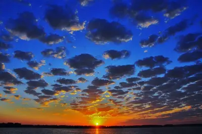a sunset with clouds in the sky over the water at Put-in-Bay Island Club #68 in Put-in-Bay
