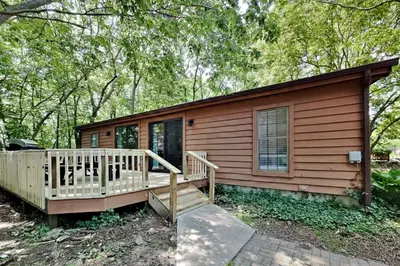 a log cabin with a porch and a deck at Put-in-Bay Island Club #68 in Put-in-Bay