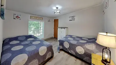 a bedroom with two beds and a window at Put-in-Bay Island Club #108 in Put-in-Bay