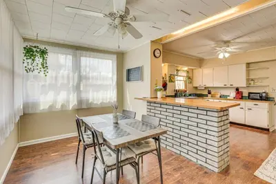 a kitchen with a table and chairs in a room at Walk to Medina Square, Historic 1880 Home in Medina