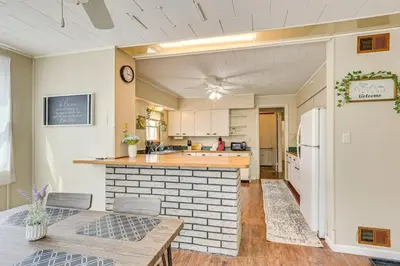 a kitchen with a table and a counter top at Walk to Medina Square, Historic 1880 Home in Medina