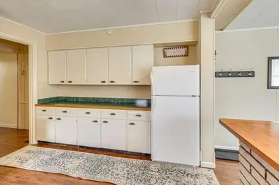 a kitchen with white cabinets and a white refrigerator at Walk to Medina Square, Historic 1880 Home in Medina