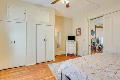 a bedroom with white cabinets and a bed and a dresser at Walk to Medina Square, Historic 1880 Home in Medina