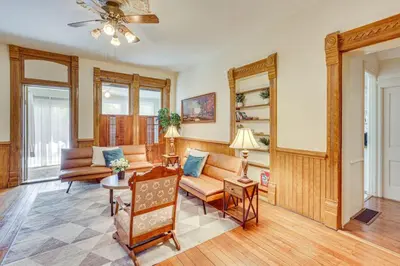 a living room with a couch and a table at Walk to Medina Square, Historic 1880 Home in Medina