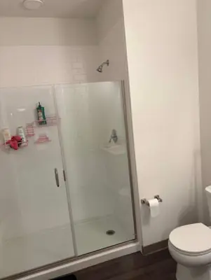 a shower stall in a bathroom with a toilet at Studio apartment with easy access to the city in Cleveland