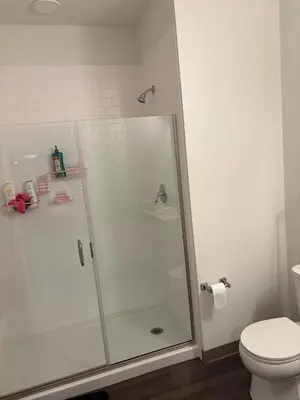 a shower stall in a bathroom with a toilet at Studio apartment with easy access to the city in Cleveland