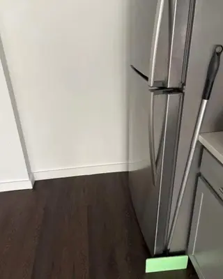 a refrigerator in a kitchen with a wooden floor at Studio apartment with easy access to the city in Cleveland