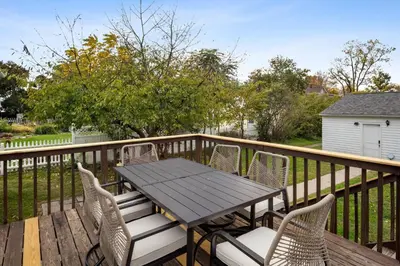 a wooden table and chairs on a deck at Newly Renovated Home <5 Mi to WEC! in Wilmington