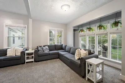 a living room with a couch and windows at Newly Renovated Home <5 Mi to WEC! in Wilmington