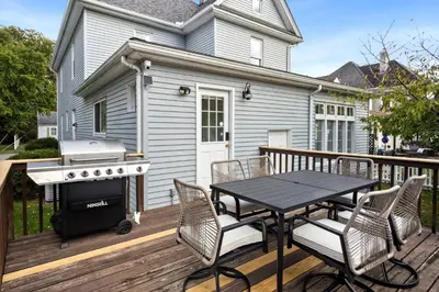 a barbecue on a deck with a table and chairs at Newly Renovated Home <5 Mi to WEC! in Wilmington