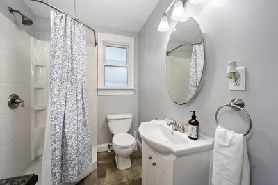 a bathroom with a sink and a toilet and a mirror at Newly Renovated Home <5 Mi to WEC! in Wilmington
