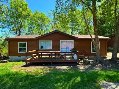 a house with a picnic table in front of it at Put-in-Bay Island Club #62 in Put-in-Bay