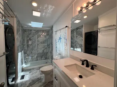 a bathroom with a sink and a toilet and a mirror at Put-in-Bay Island Club #62 in Put-in-Bay