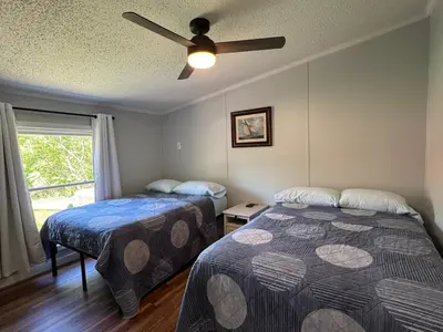 a bedroom with two beds and a ceiling fan at Put-in-Bay Island Club #62 in Put-in-Bay