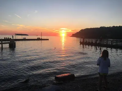 a girl standing on the beach watching the sunset at Put-in-Bay Island Club #62 in Put-in-Bay