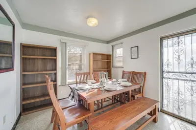 a dining room with a wooden table and chairs at Red Line to Downtown! Inviting Home in Cleveland in Cleveland
