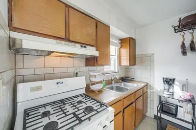 a kitchen with a white stove and a sink at Red Line to Downtown! Inviting Home in Cleveland in Cleveland