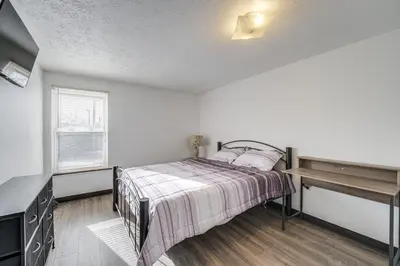 a bedroom with a bed and a desk at Red Line to Downtown! Inviting Home in Cleveland in Cleveland