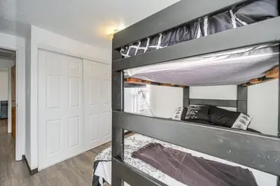 a bunk bed in a room with a door at Red Line to Downtown! Inviting Home in Cleveland in Cleveland