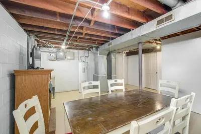 a dining room with a table and white chairs at Red Line to Downtown! Inviting Home in Cleveland in Cleveland