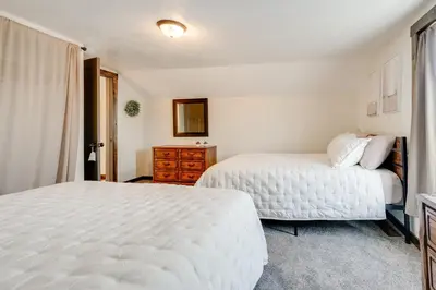 a white bedroom with two beds and a dresser at Amish Country Escape Decatur Family Farmhouse in Decatur