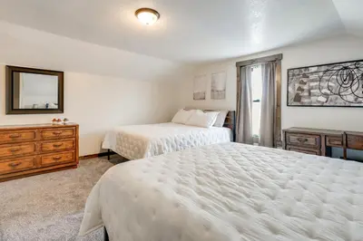 a bedroom with two beds and a mirror at Amish Country Escape Decatur Family Farmhouse in Decatur