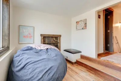 a living room with a bed and a fireplace at Amish Country Escape Decatur Family Farmhouse in Decatur