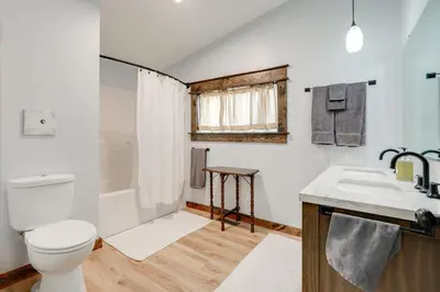 a bathroom with a toilet and a sink at Amish Country Escape Decatur Family Farmhouse in Decatur
