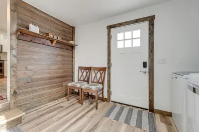 a room with a white door and a wooden wall at Amish Country Escape Decatur Family Farmhouse in Decatur