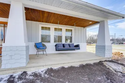 a porch with a blue couch and a chair at Amish Country Escape Decatur Family Farmhouse in Decatur