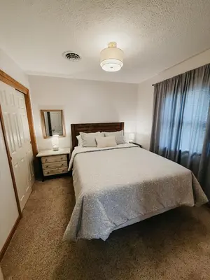 a bedroom with a large bed and a window at Cozy bungalow in the heart of historic Marysville in Marysville