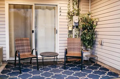 two chairs and a table on a porch at Cozy bungalow in the heart of historic Marysville in Marysville