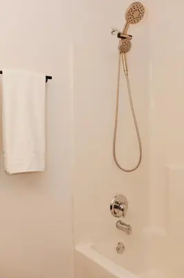 a white bathroom with a shower and a sink at Cozy bungalow in the heart of historic Marysville in Marysville
