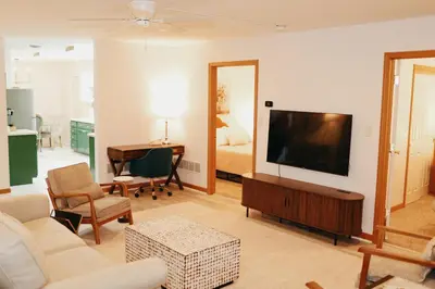 a living room with a television and a bedroom at Cozy bungalow in the heart of historic Marysville in Marysville